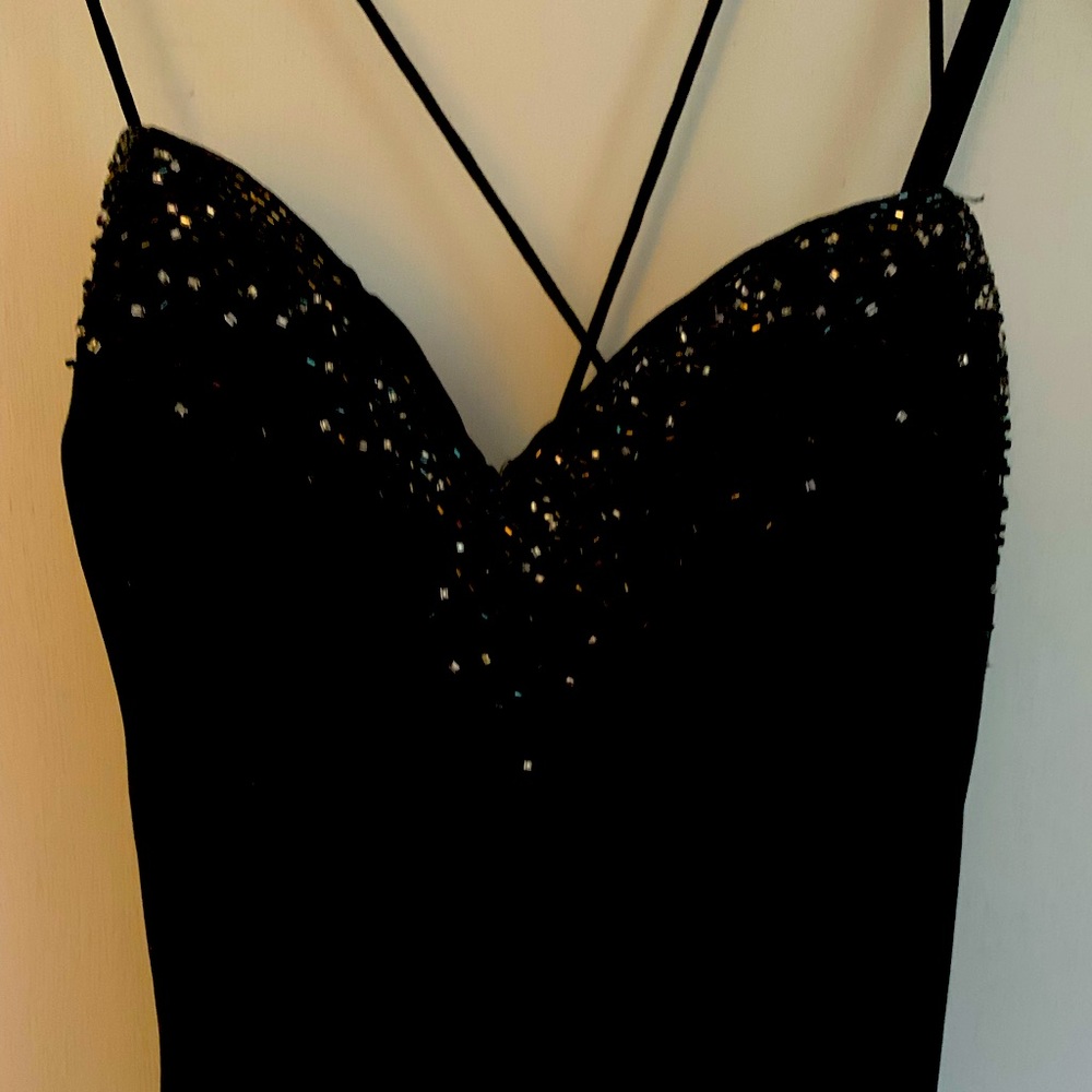 Black, backless, beautiful evening gown. Dry cleaned and no flaws. Size 10